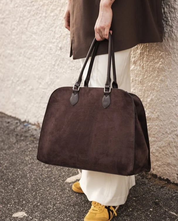 woman wearing large suede tote bag