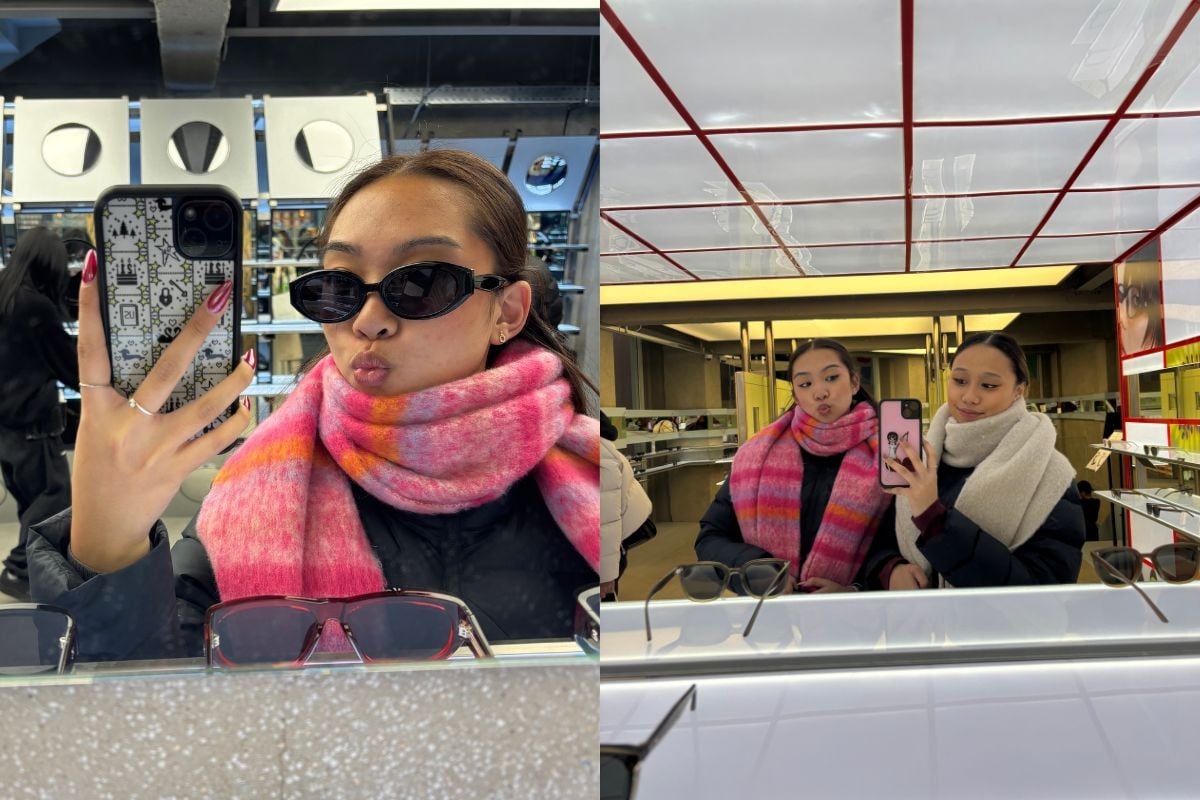 Girl with sunglesses posing in front of mirror. Two girls posing in front of mirror.