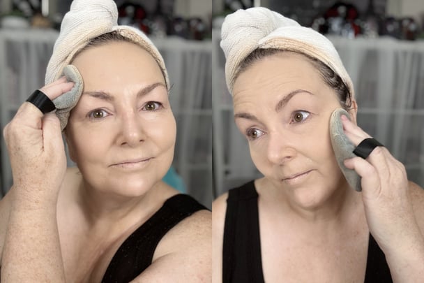 Teresa applying powder on her face using a large puff.