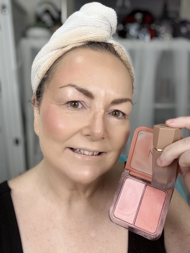 Teresa layering cream makeup products over her set powder.
