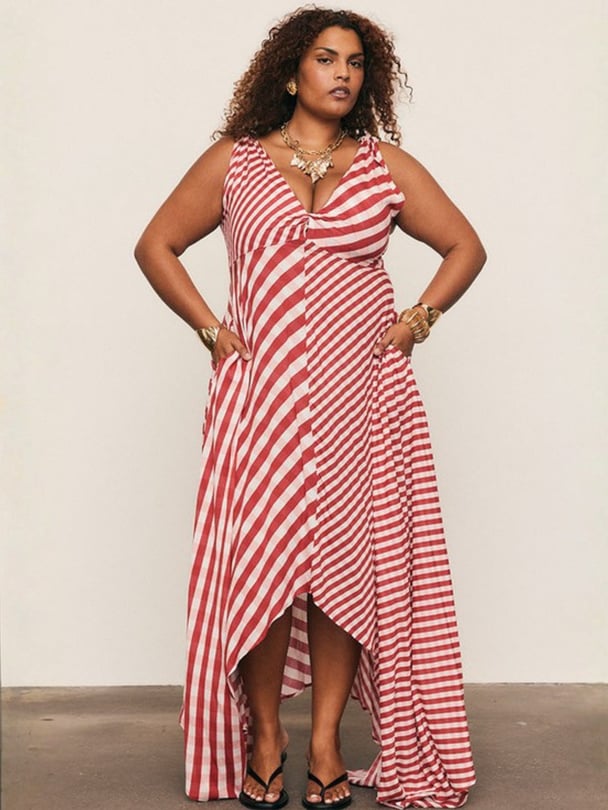 Model posing in red, white and pink gingham dress.