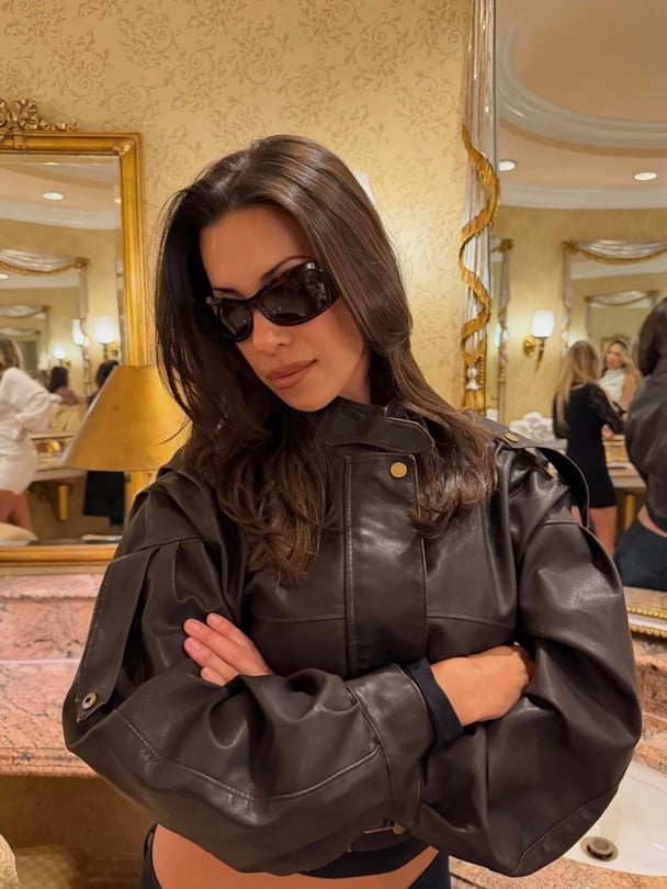 woman wearing lioness brown bomber leather jacket.