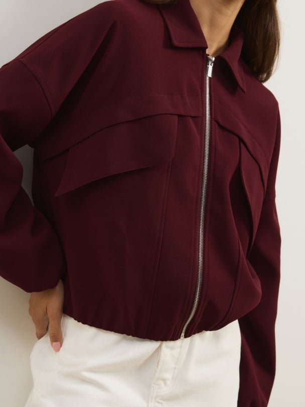 woman wearing Atmos&Here berry bomber jacket