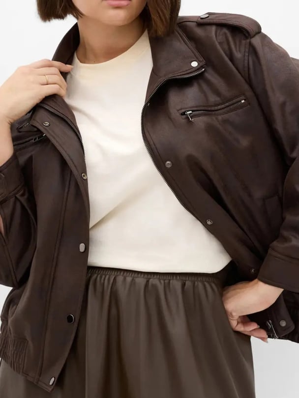 woman wearing city chic brown bomber leather jacket.