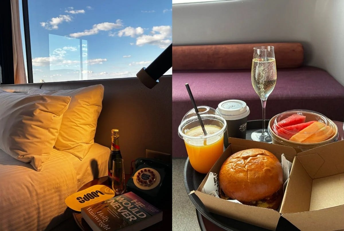 hotel bed with champagne fruit and coffee 