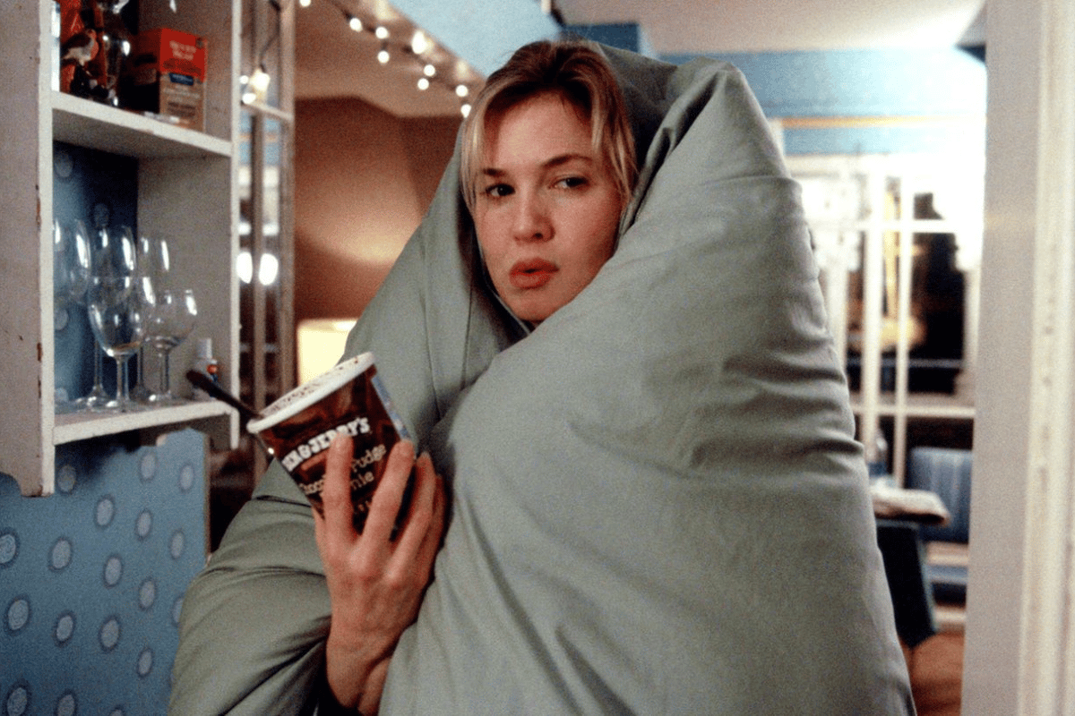 Bridget Jones eating ice cream and wearing a blanket in Bridget Jones's Diary.