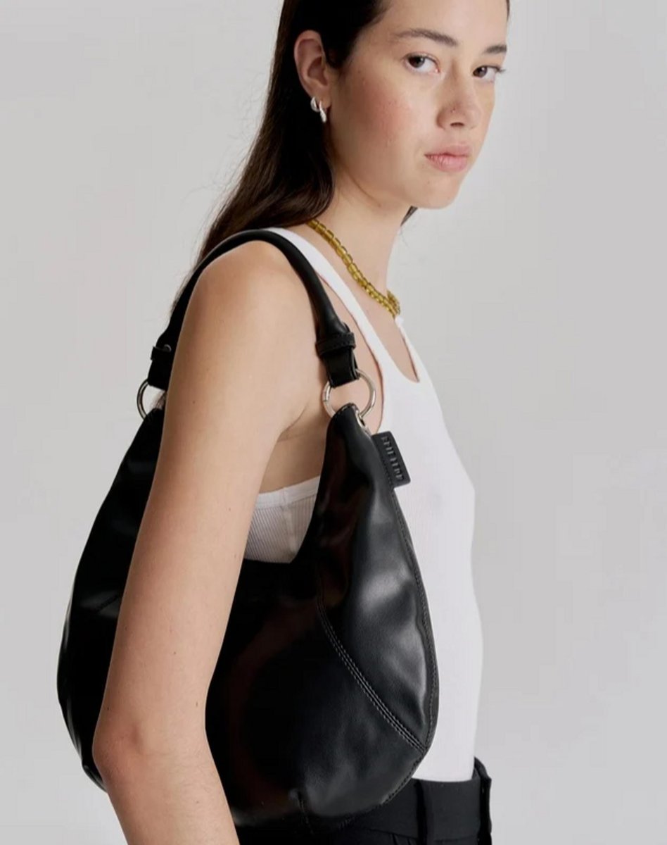 woman wearing black shoulder bag 