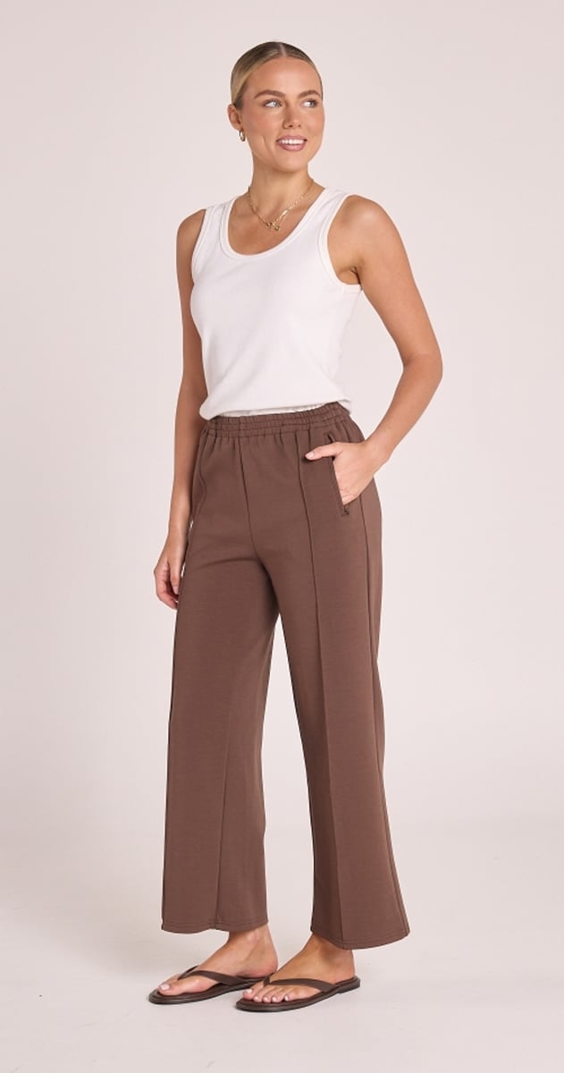 woman wearing brown cropped track pants from Feather + Noise