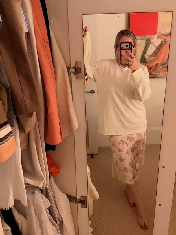 Ali wearing longsleeves white top from Buddy and floral skirt.