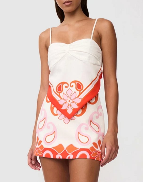 woman wearing a twin set white and orange patterns By Johnny Sierra Paradiso Tie Back Cami, and Sierra Paradiso Mini Skirt