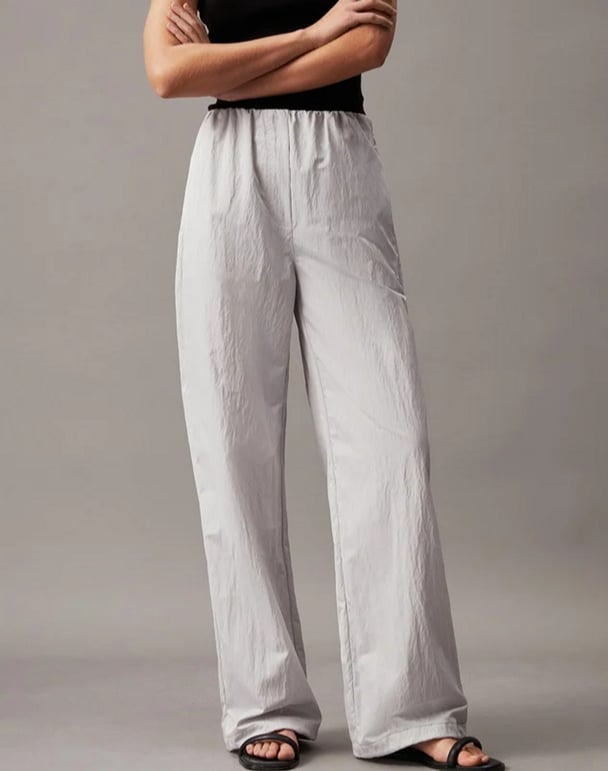 woman wearing relaxed fit grey Calvin Klein parachute pants
