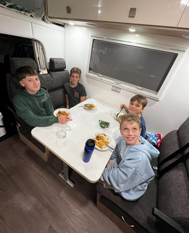 kids eating a meal inside a motorhome