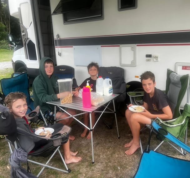 kids eating cereal at a camping site