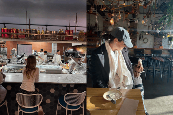 Children sitting at a restaurant bar while chefs cook behind on the left, a mum and her son at a breakfast cafe, dressed for winter.