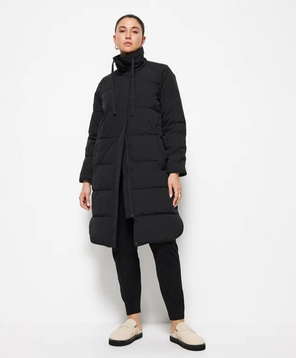 woman wearing a long puffer jacket from Commonry