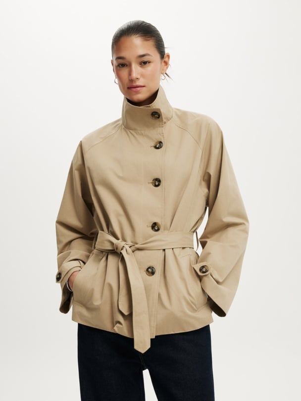 Cropped trench coat in tan with belt.
