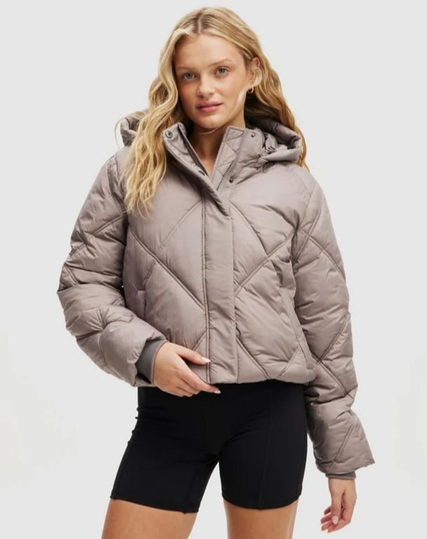 woman wearing a beige puffer jacket from Cotton On
