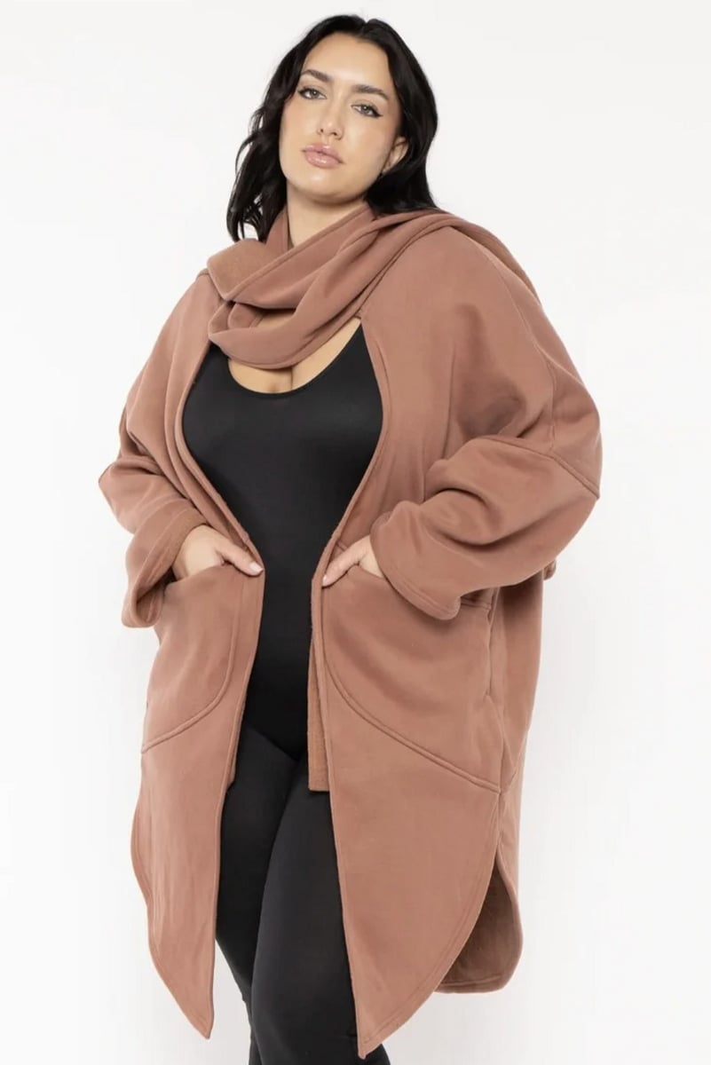 woman wearing a terracotta coloured all in one knit with scarf 