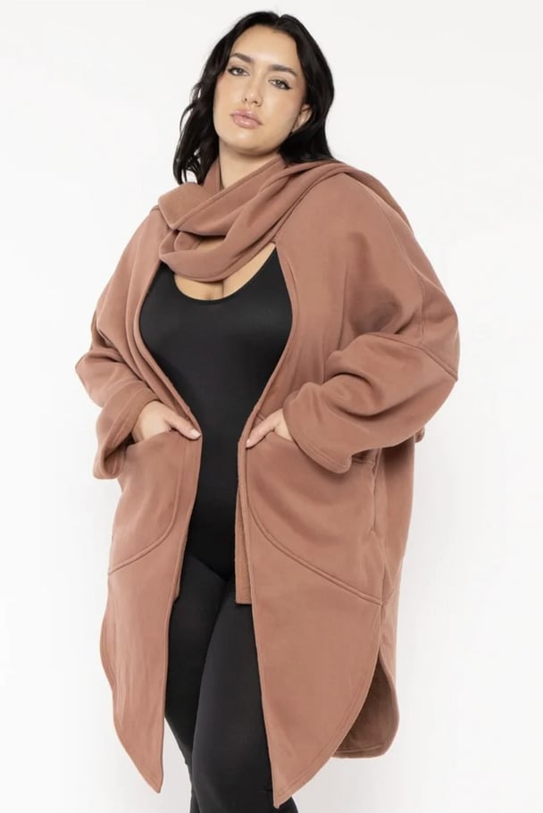woman wearing a terracotta coloured all in one knit with scarf