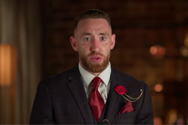 Danny talks to the camera in an aside.