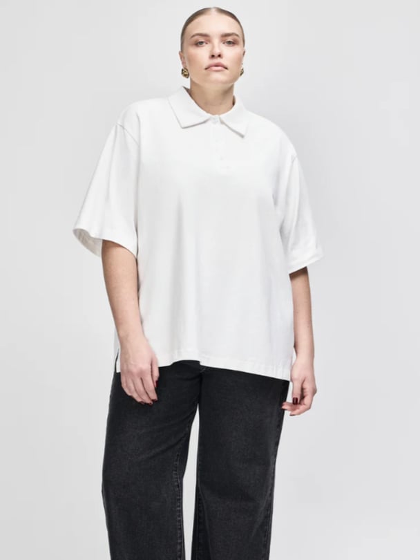 Model in oversized white polo shirt.