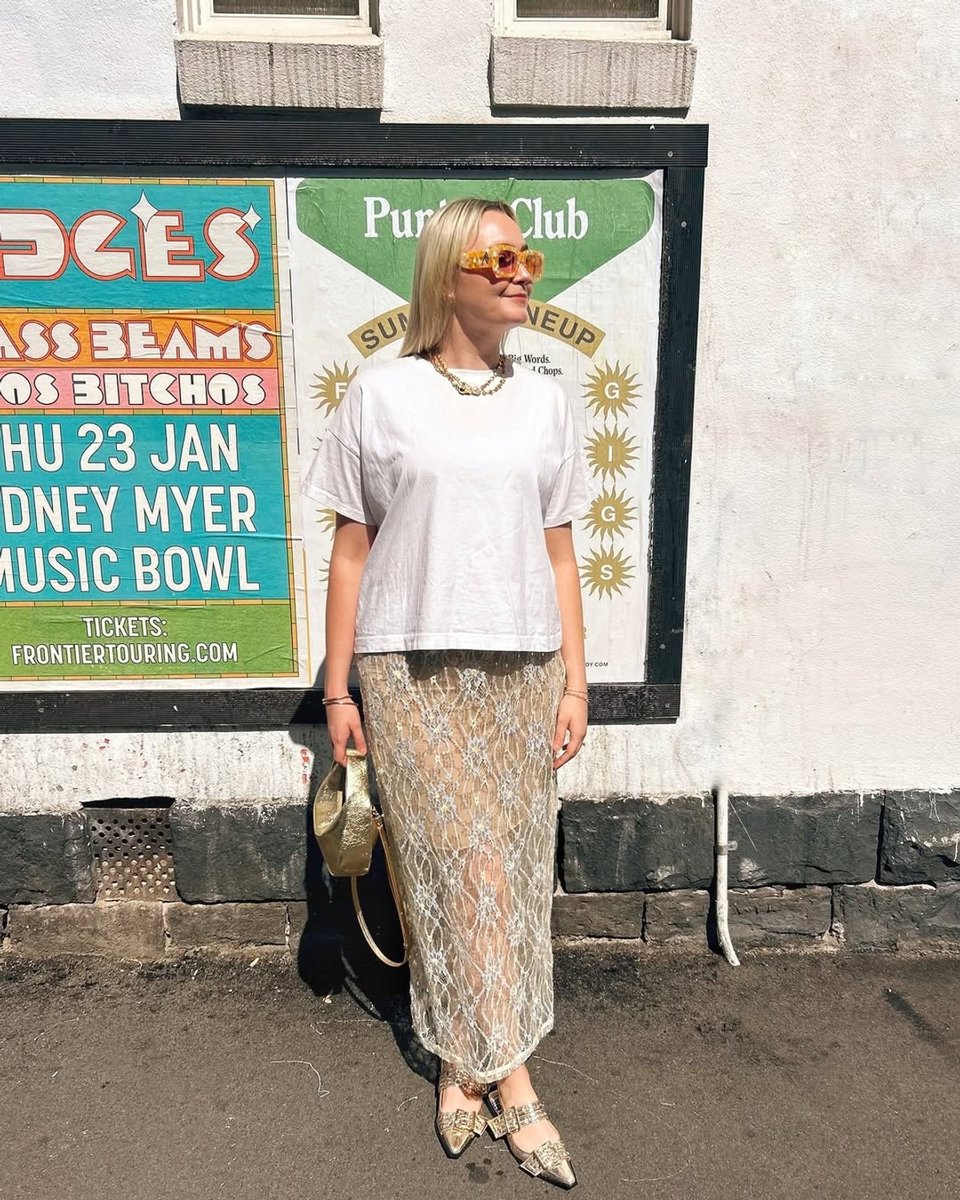 A creator in an embellished sheer skirt and t shirt