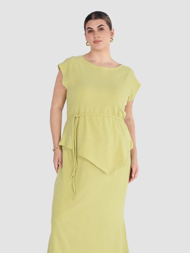 Model in bright green tie up sleeveless top.