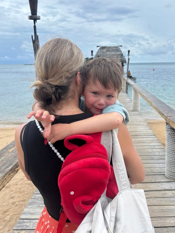 Zoe carrying her toddler on the wharf.