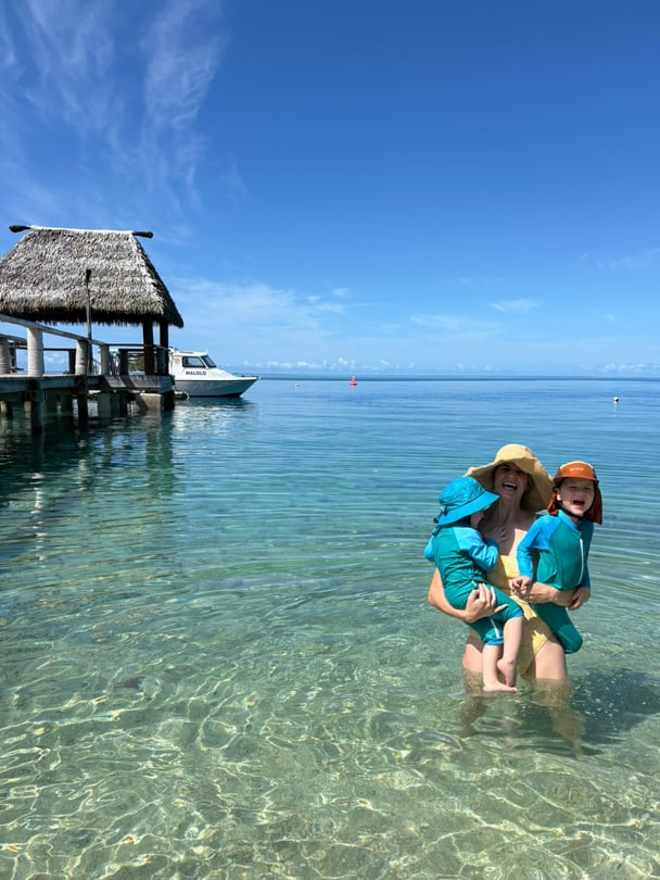 Zoe and her two children in the water.