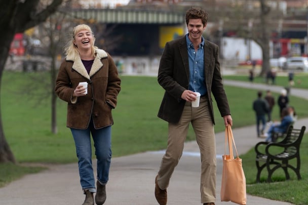 Florence Pugh and Andrew Garfield walking on the street in a scene for We Live In Time.