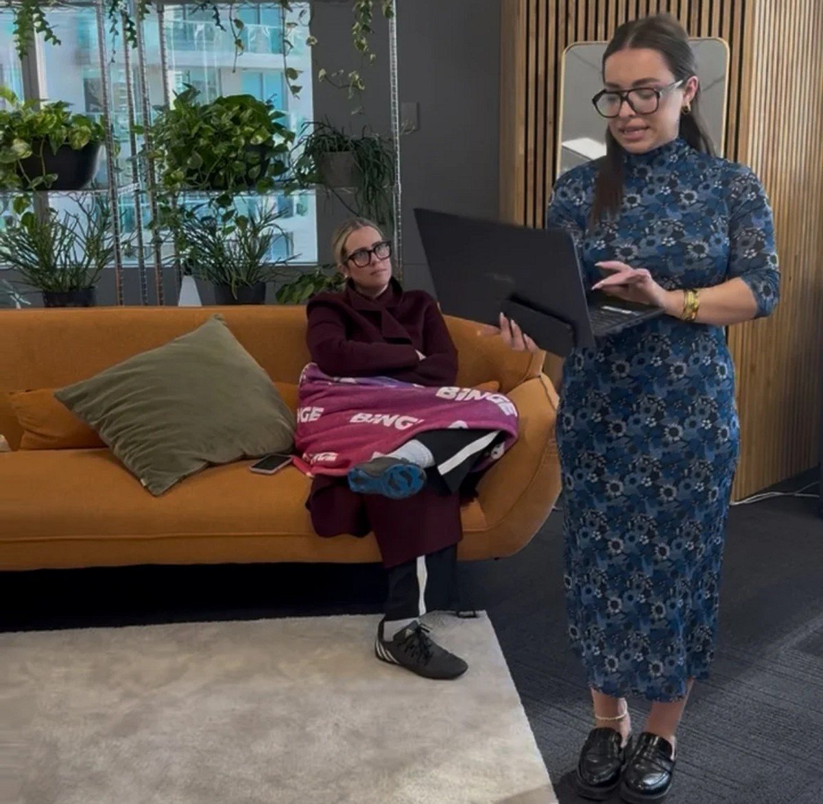 woman wearing football boots to a meeting. 