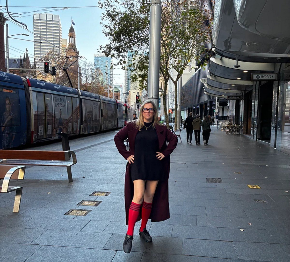 woman wearing soccer socks and football boots in the city. 