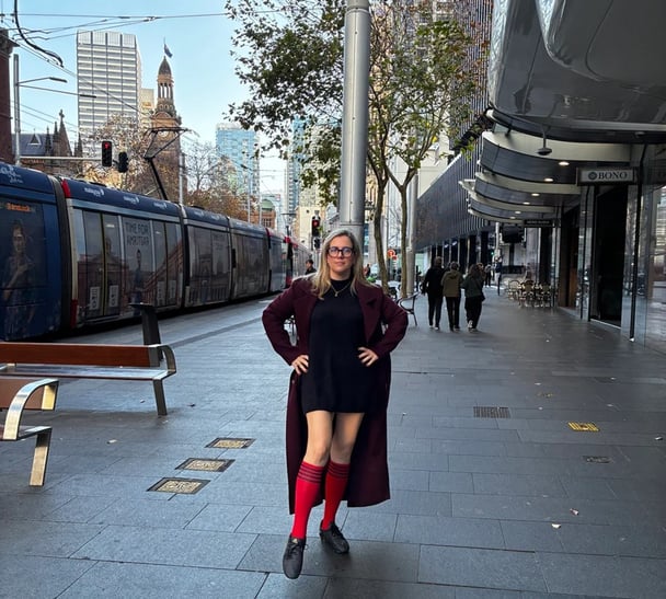 woman wearing soccer socks and football boots in the city.