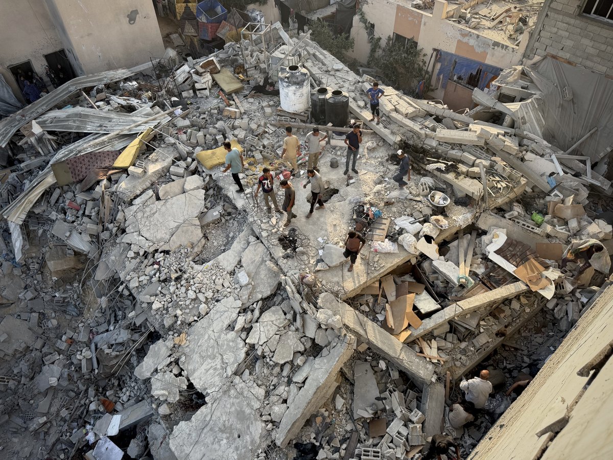 Palestinians inspect the rubble of the destroyed house following an Israeli airstrike on the Mawasi neighborhood.