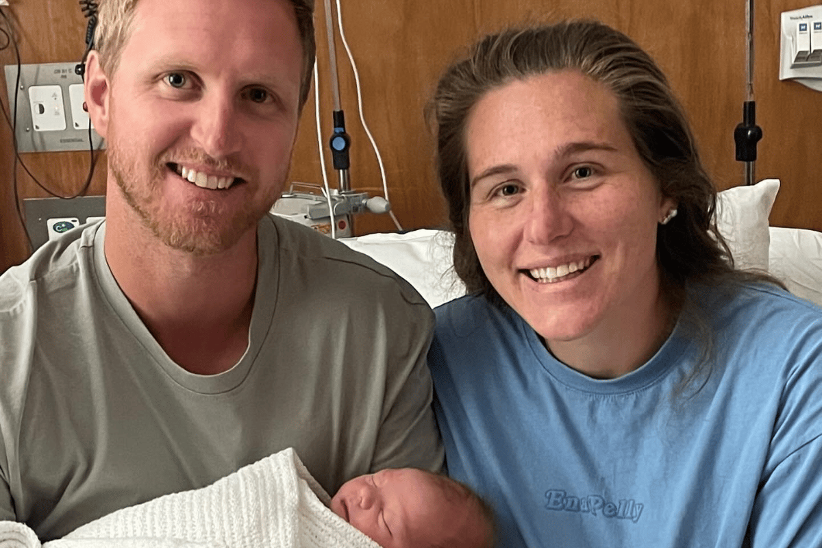 Georgia Inglis poses with her husband Mitch Brown and their baby Austin in the hospital after giving birth.