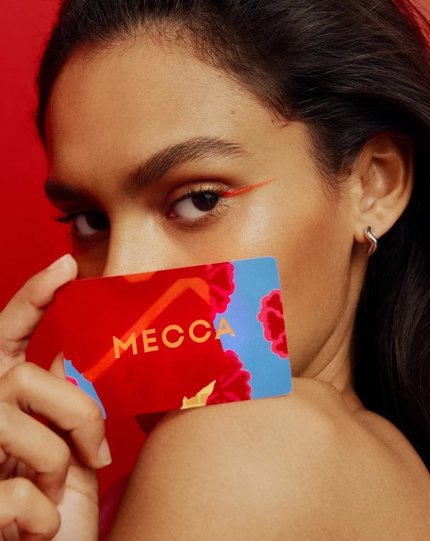 woman holding Mecca gift card