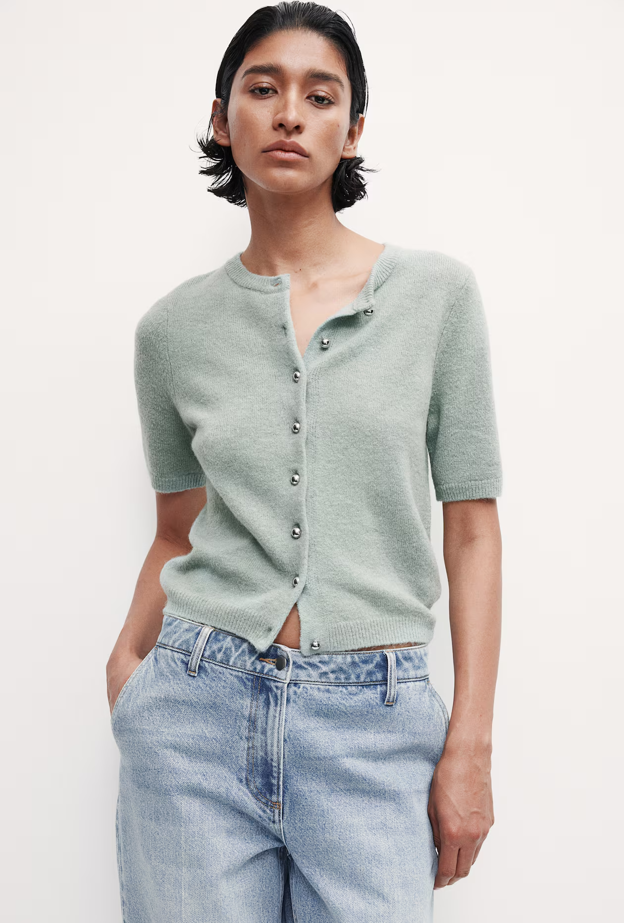 woman wearing knit sage green top