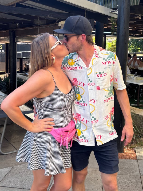 Heidi and her husband kissing.