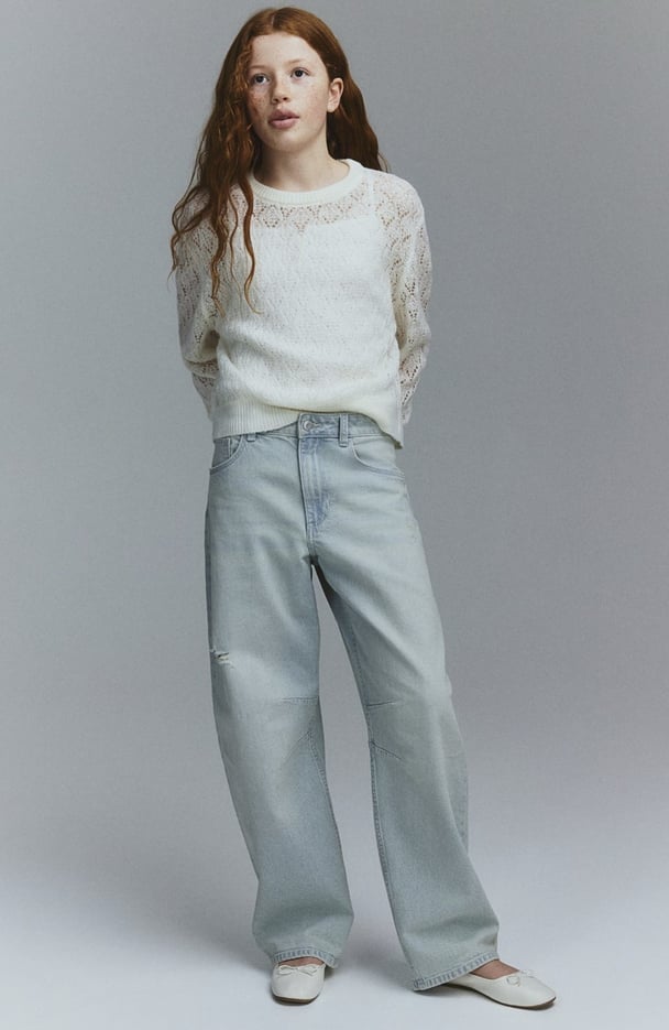 woman wearing baggy distressed jeans