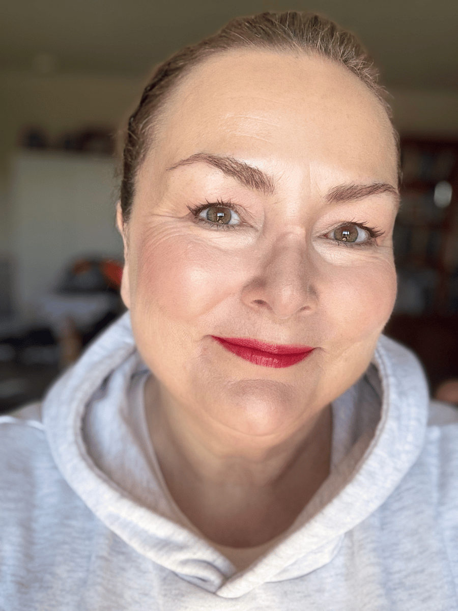 Teresa smiling selfie with a red lip.