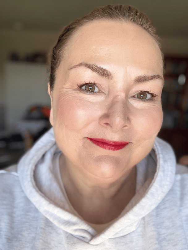 Teresa smiling selfie with a red lip.