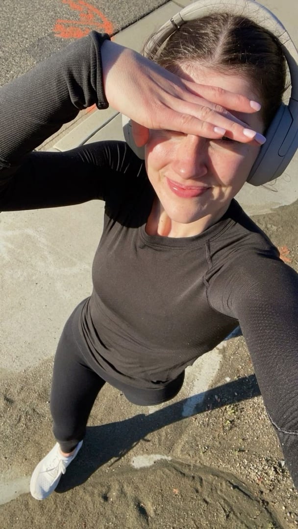 A woman in active clothing is out walking.