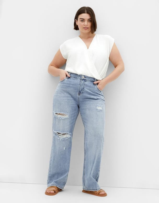 woman wearing distressed jeans from City Chic 