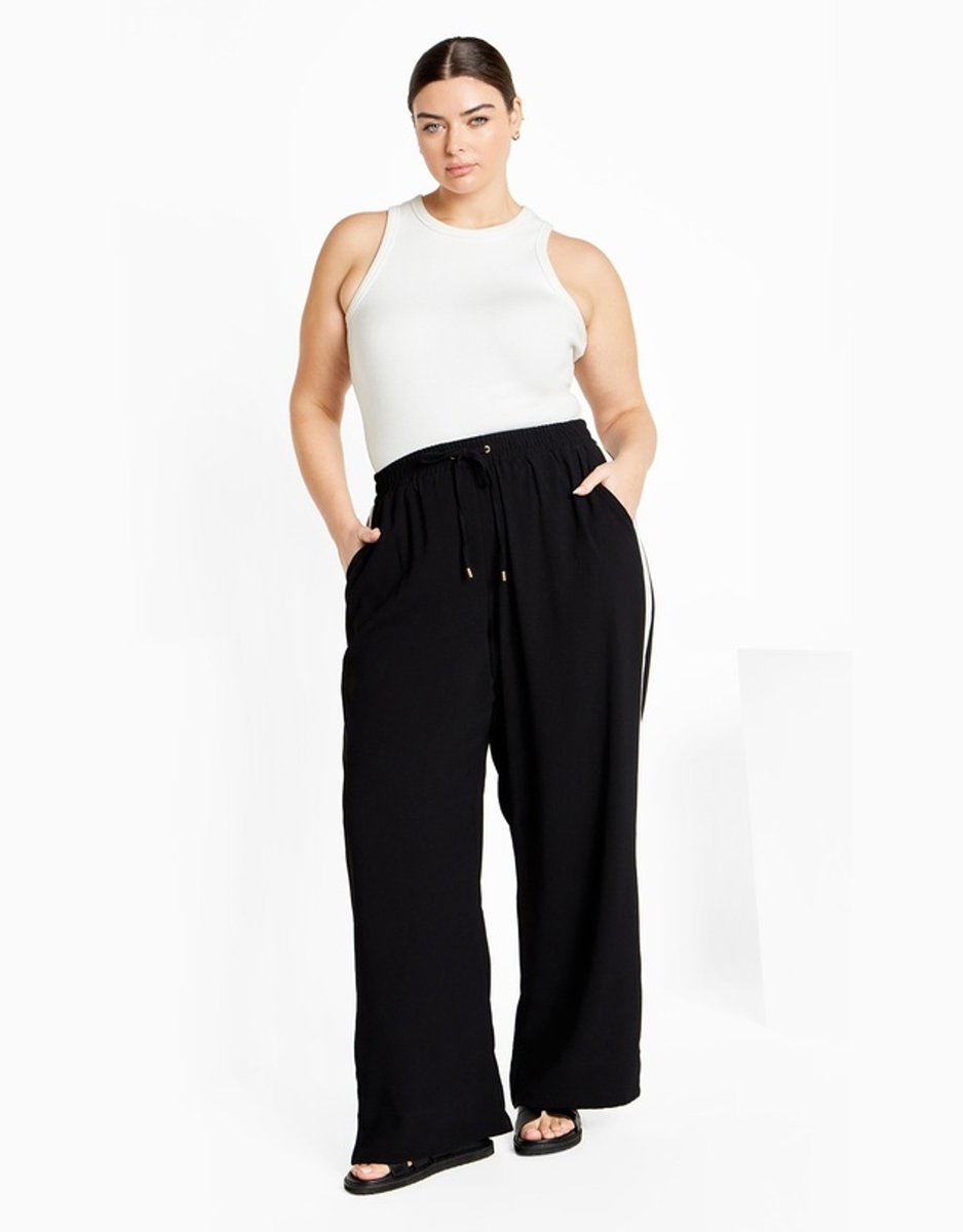 woman wearing black pants with contrast stripe from City Chic