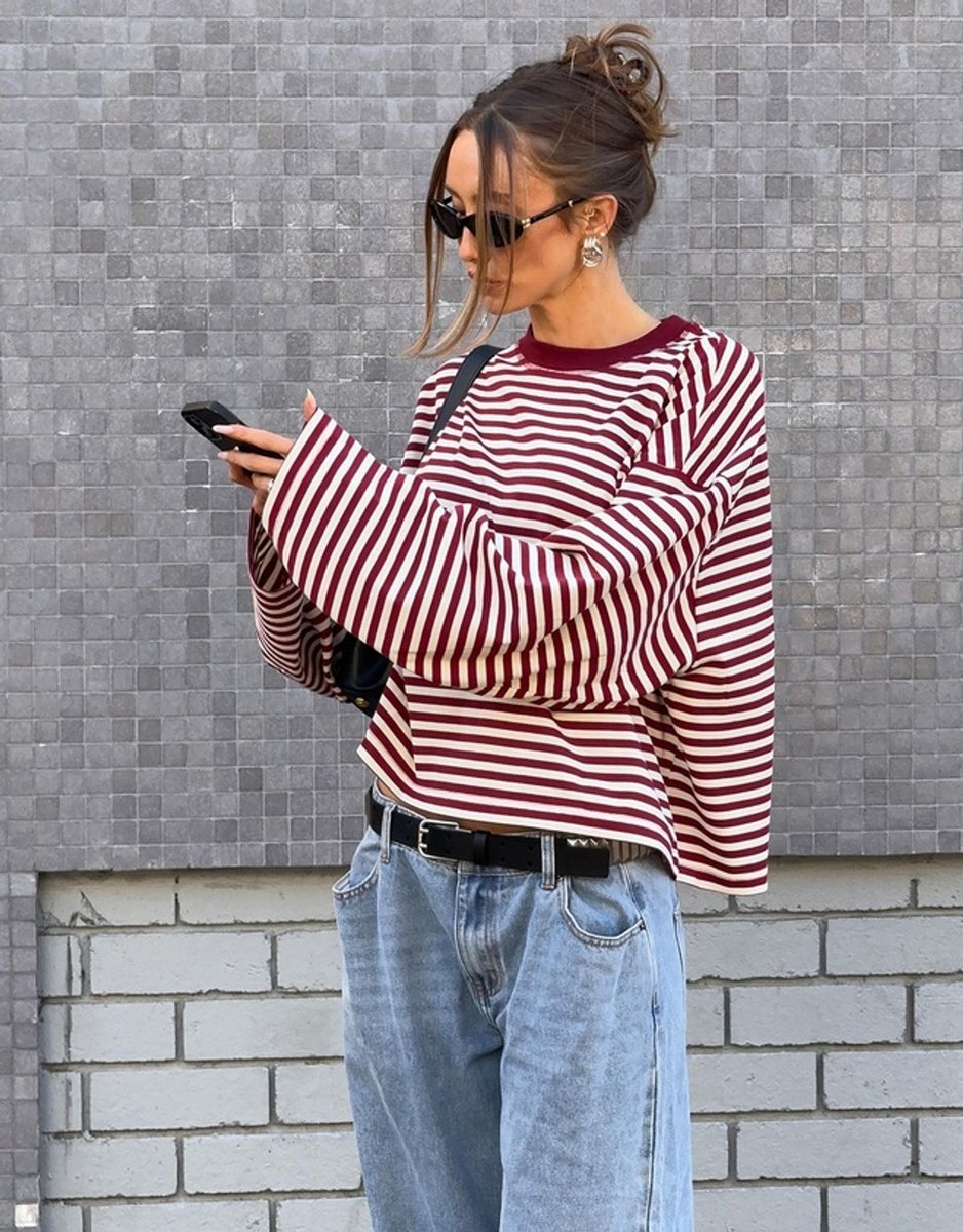 Woman wearing the bloom long-sleeved top in wine stripe.