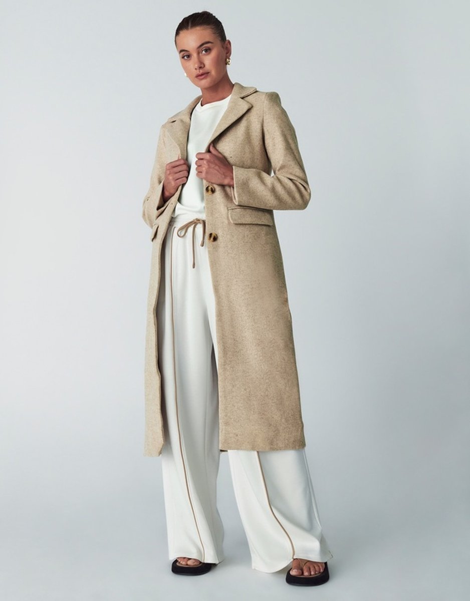 woman wearing tan maxi coat from Willa
