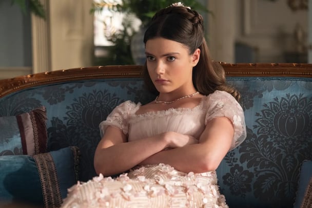 Hyacinth Bridgerton sits glumly on lounge.