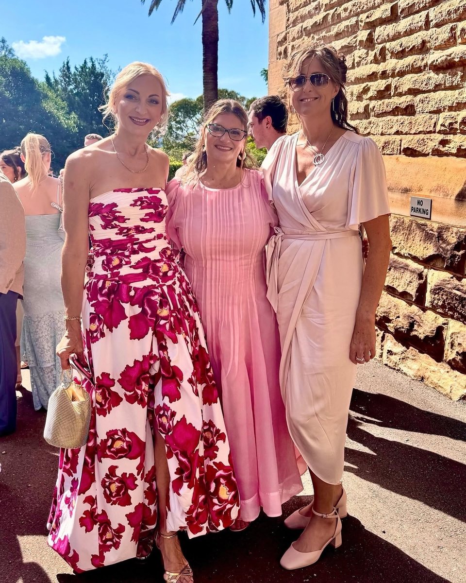 Louise and Rachel posing at a formal event with smiles.