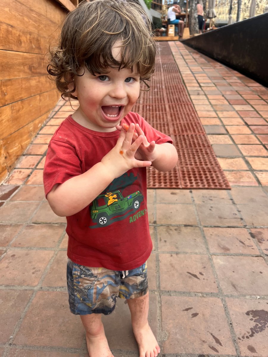 Little Joe Massa smiles in a red tshirt.