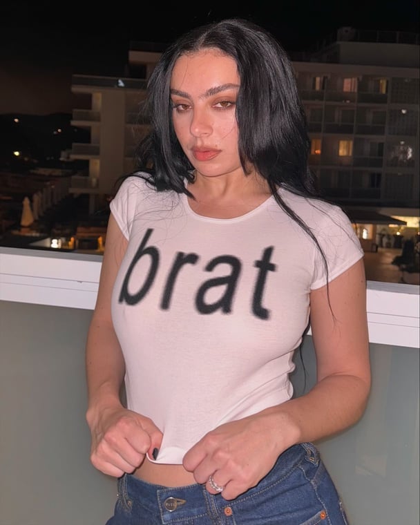 A photo of musician Charl XCX in a tight t-shirt with